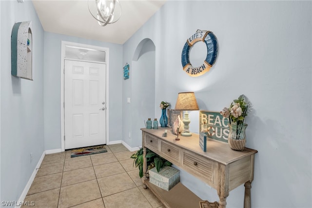 entrance foyer featuring a notable chandelier and light tile patterned floors