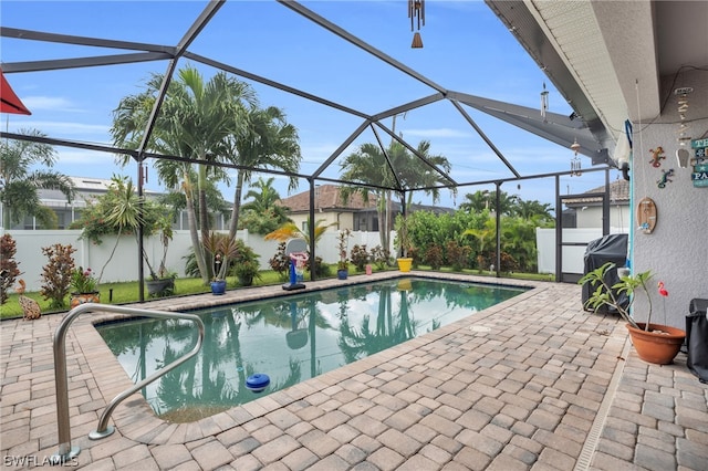 view of swimming pool with a patio and glass enclosure