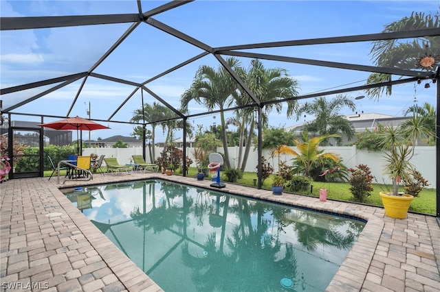 view of swimming pool featuring a patio area and a lanai