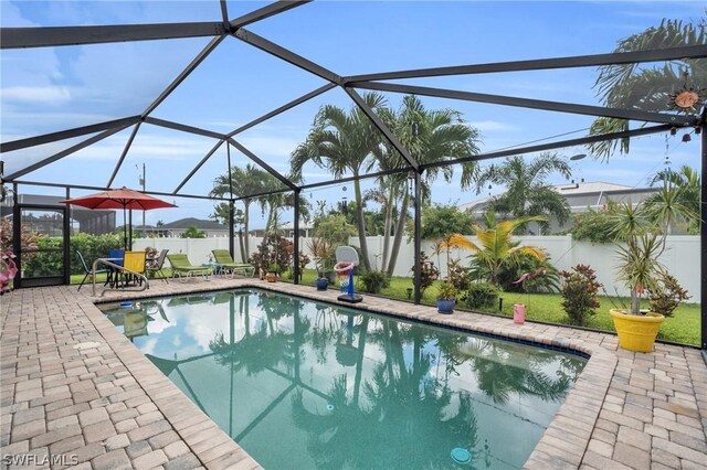 view of swimming pool featuring a patio area and glass enclosure