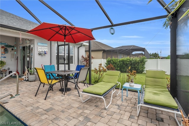 view of patio featuring a lanai