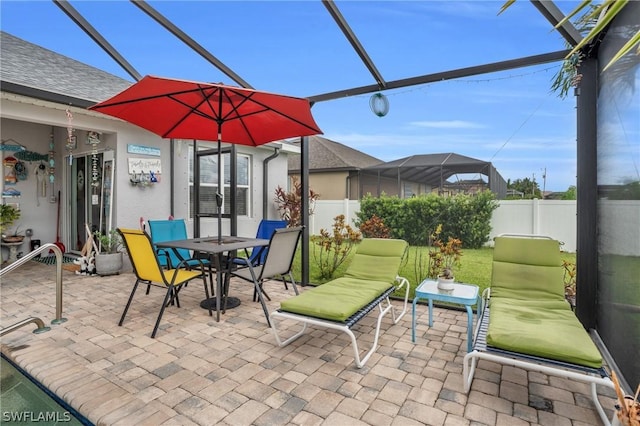 view of patio / terrace featuring glass enclosure