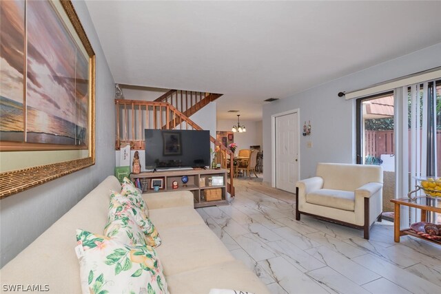 tiled living room featuring an inviting chandelier