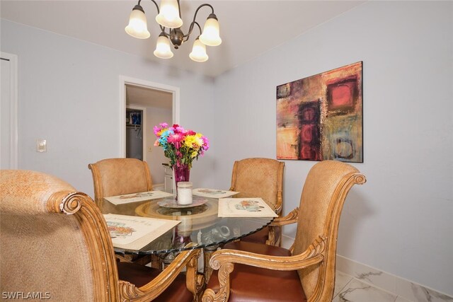 dining room with tile patterned floors and a chandelier