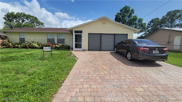 single story home with a garage and a front yard