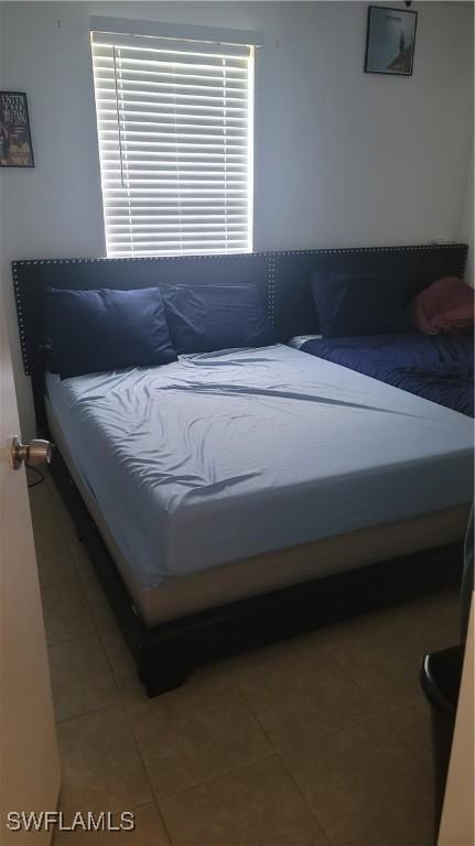 bedroom featuring light tile patterned floors