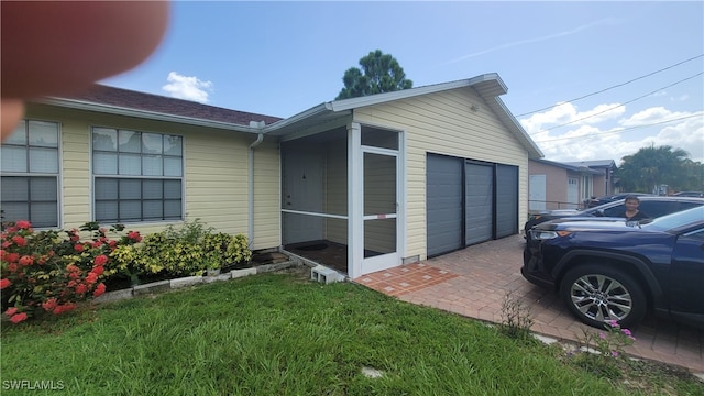 view of property exterior featuring a garage and a yard