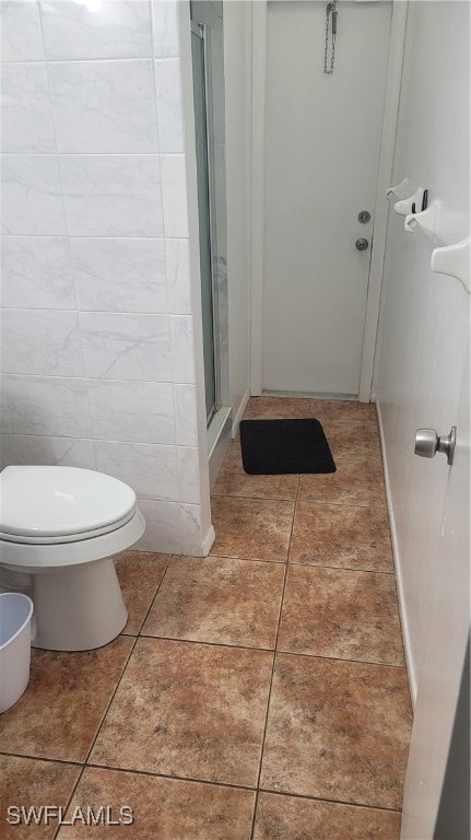 bathroom with walk in shower, tile walls, toilet, and tile patterned floors