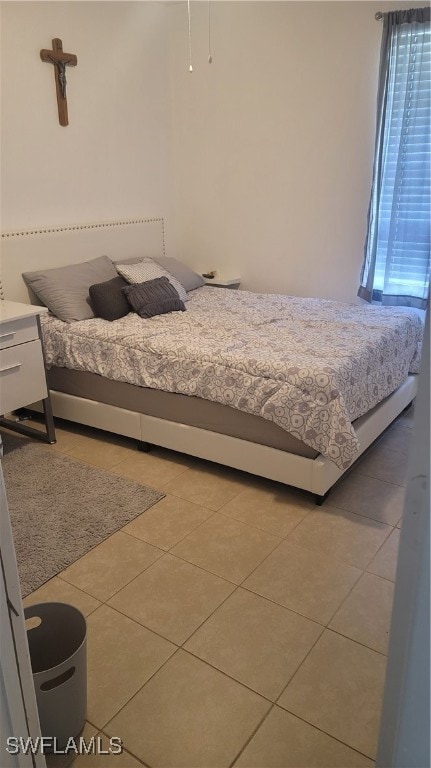 bedroom with light tile patterned floors