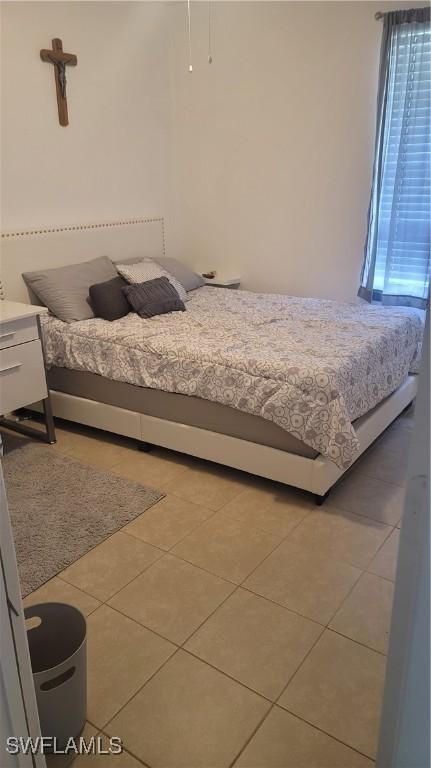 bedroom featuring light tile patterned floors