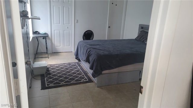 bedroom with light tile patterned floors