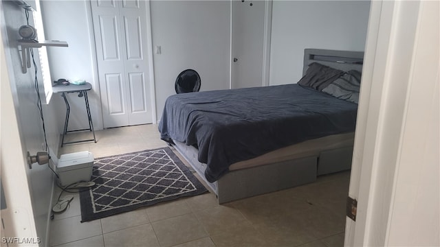 bedroom featuring light tile patterned flooring and a closet