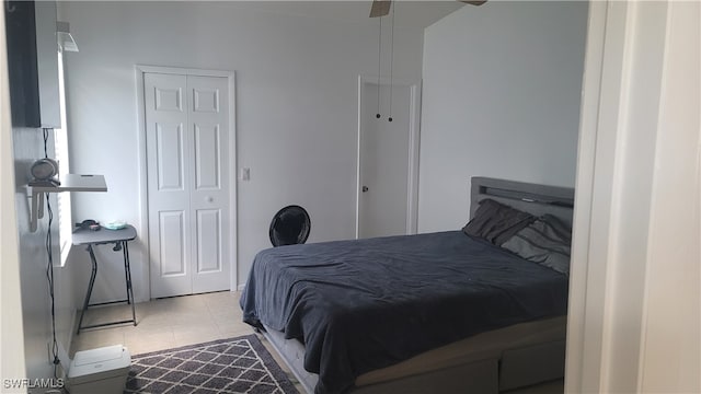 tiled bedroom featuring ceiling fan