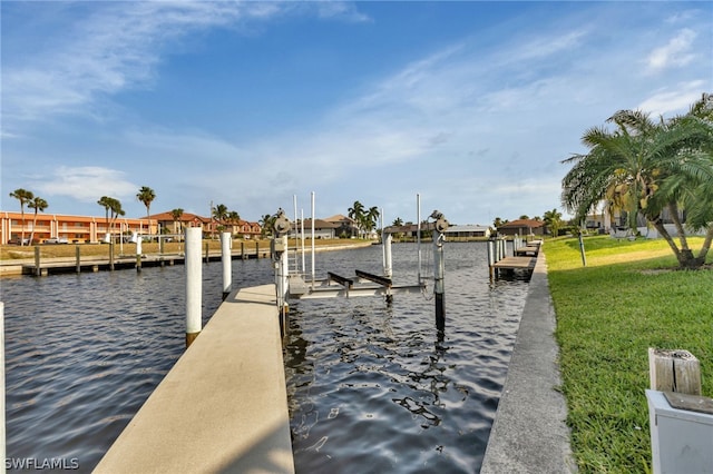 view of dock featuring a water view and a lawn