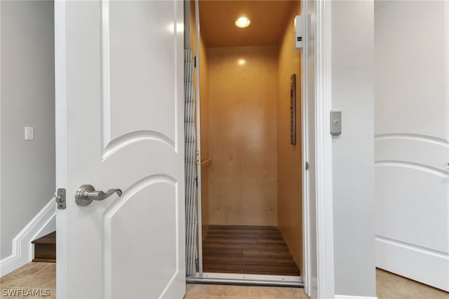 bathroom with tile patterned flooring and elevator