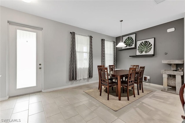 dining area with plenty of natural light and baseboards