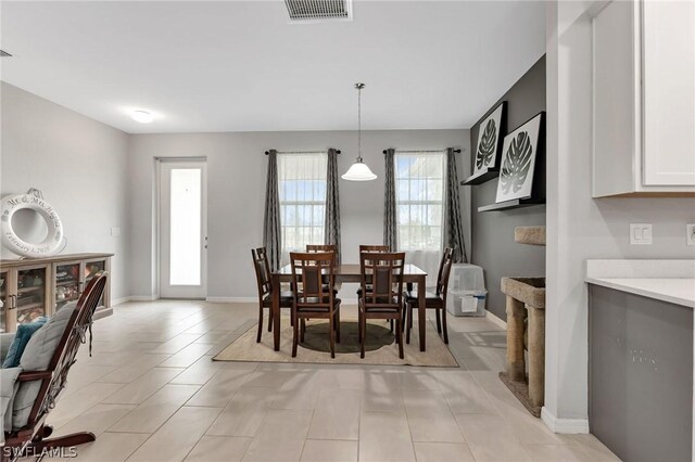 tiled dining space with a healthy amount of sunlight