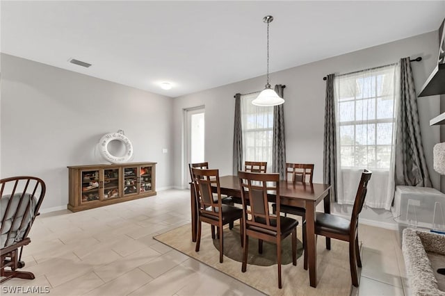 dining area featuring plenty of natural light, visible vents, and baseboards