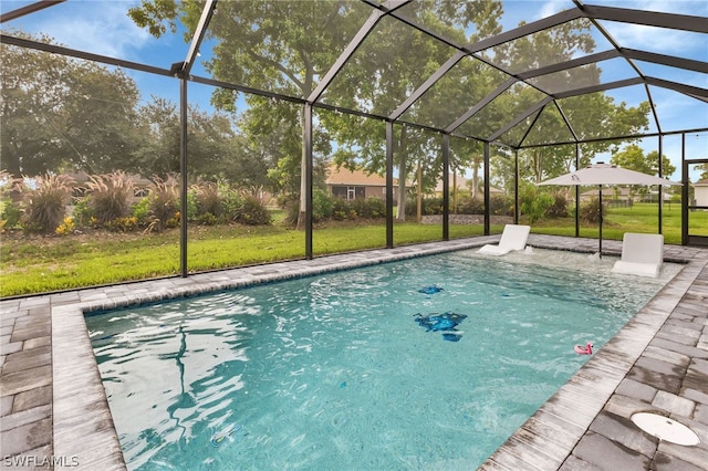 view of swimming pool featuring glass enclosure and a yard