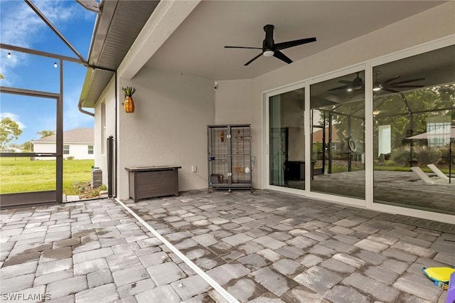 unfurnished sunroom with ceiling fan