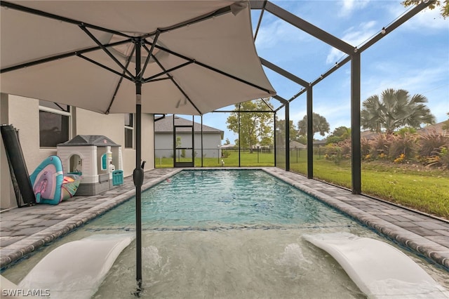 view of pool with a lanai and a lawn