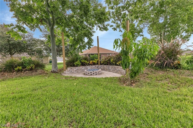 view of yard with a fire pit and a patio