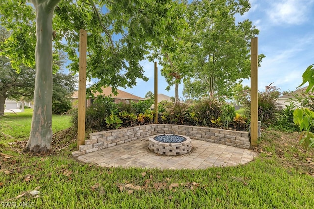 view of yard with a patio area and an outdoor fire pit