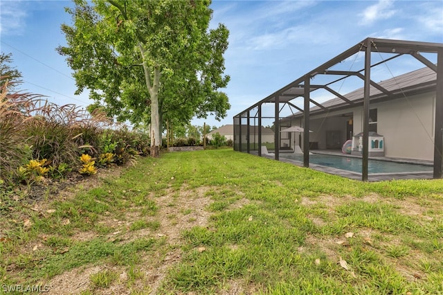 view of yard with a lanai and a patio