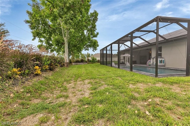 view of yard featuring a lanai and an outdoor pool