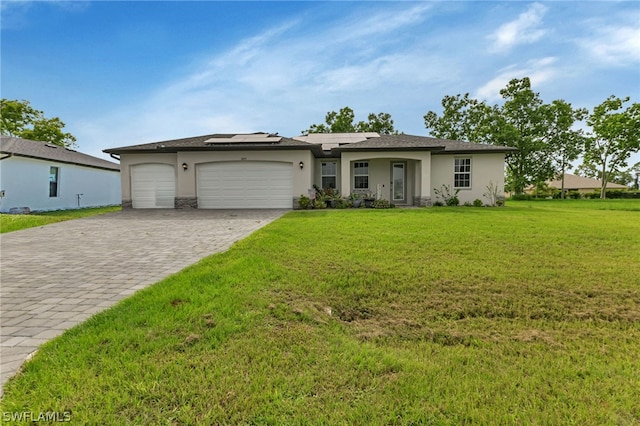 ranch-style home with a garage and a front yard