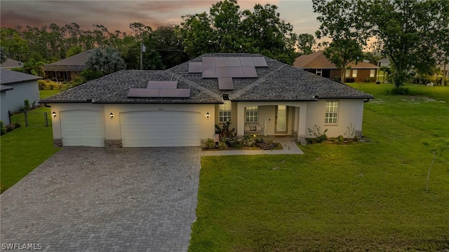 view of front facade with an attached garage, a front lawn, and stucco siding