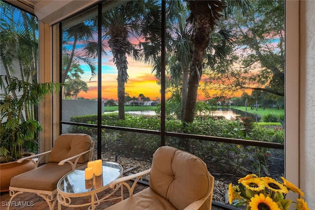 sunroom / solarium featuring a water view