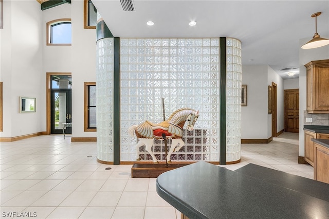 hall featuring light tile patterned floors