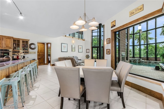 dining room with a notable chandelier, light tile patterned flooring, and sink