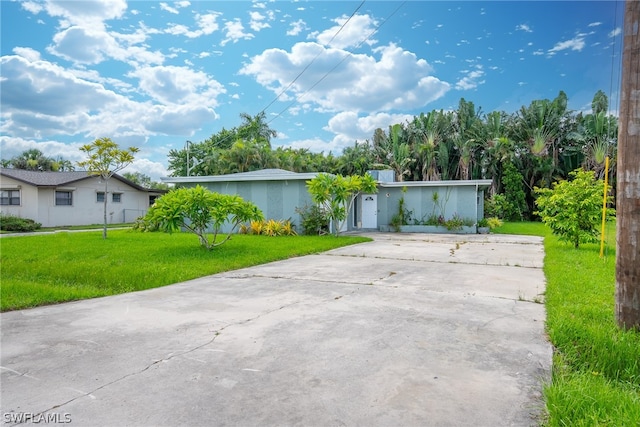 ranch-style house with a garage and a front lawn