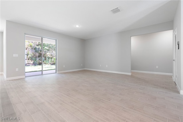 spare room with light hardwood / wood-style floors