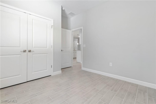 unfurnished bedroom featuring a closet and light wood-type flooring