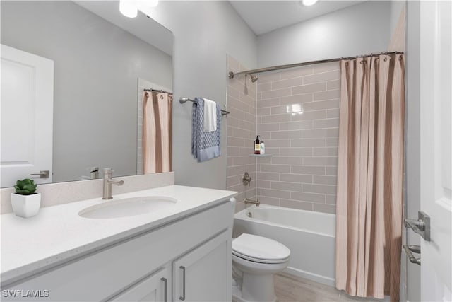 full bathroom featuring shower / tub combo with curtain, vanity, and toilet