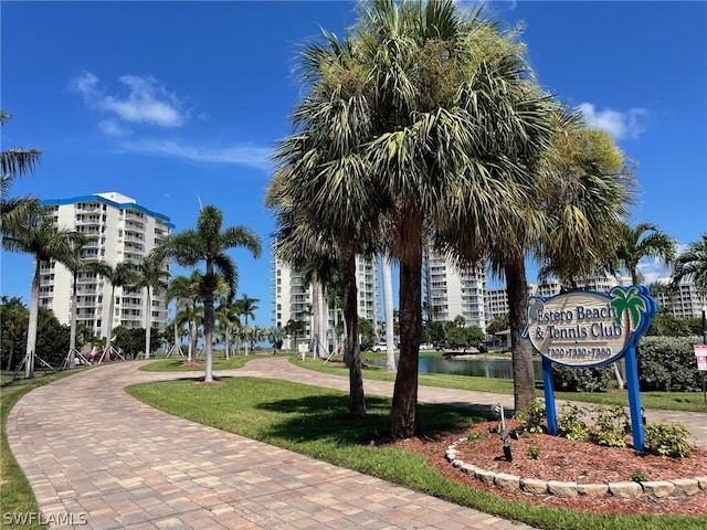 surrounding community featuring a yard and a water view