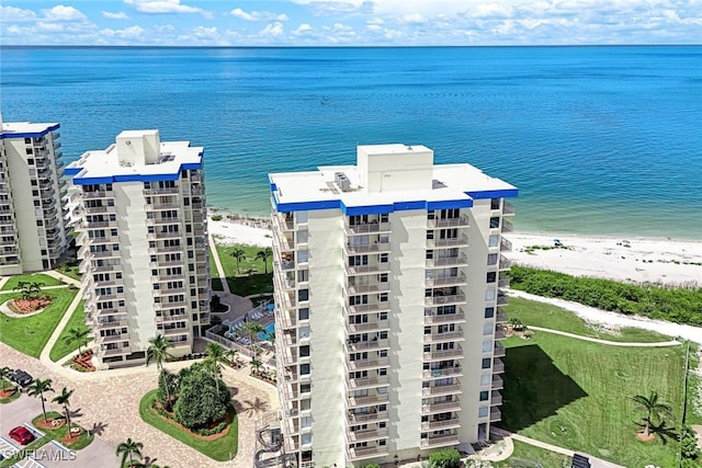 birds eye view of property featuring a beach view and a water view