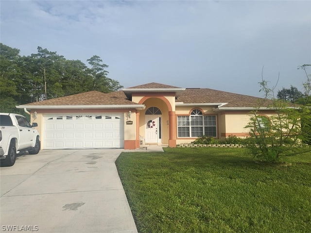 view of front facade with a garage and a front yard