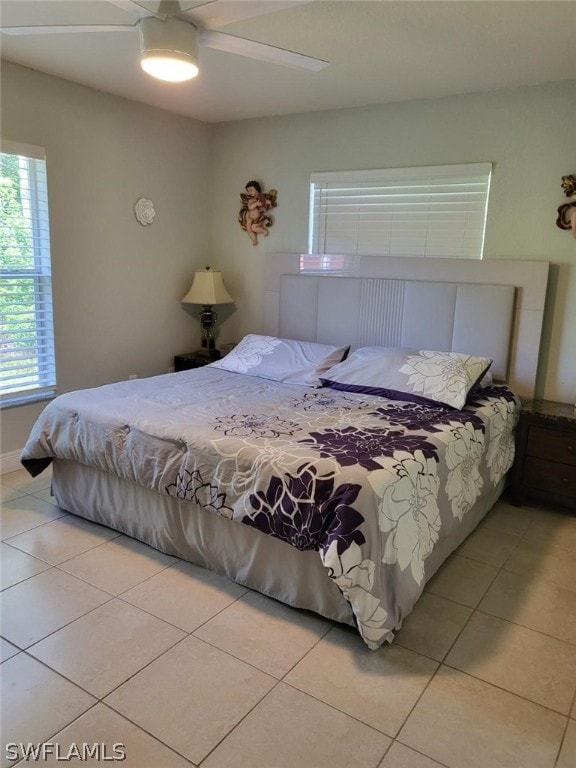 bedroom with ceiling fan and light tile patterned floors