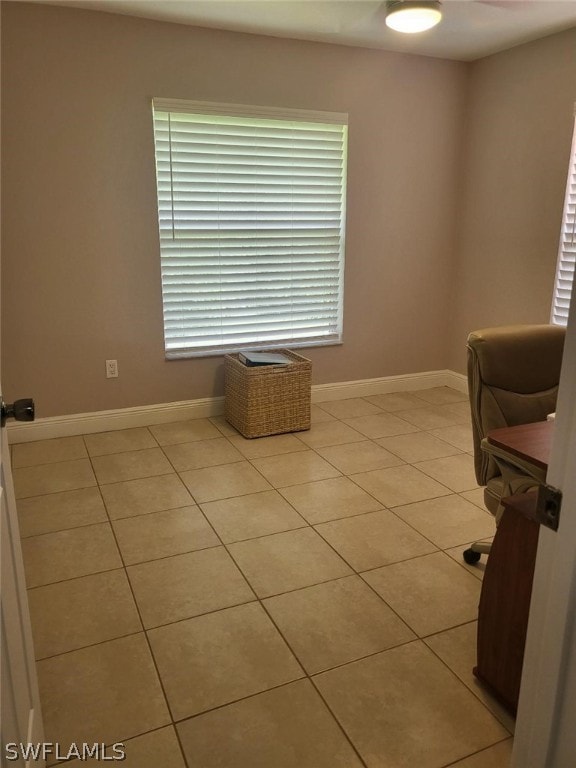 unfurnished office featuring light tile patterned floors