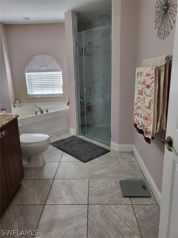 full bathroom with independent shower and bath, vanity, tile patterned flooring, and toilet