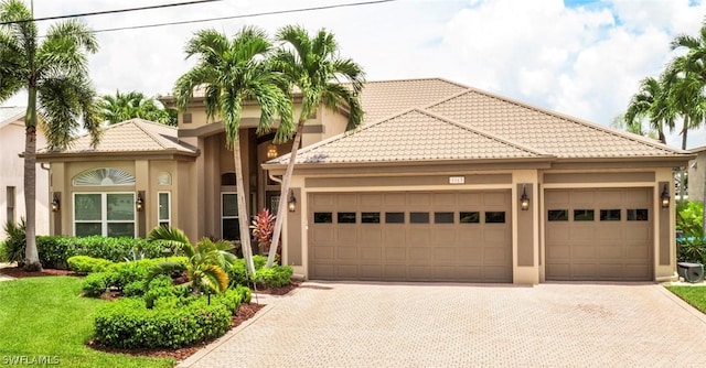 mediterranean / spanish house featuring a garage