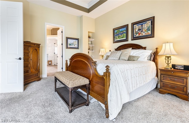 bedroom with light carpet, crown molding, a raised ceiling, and ensuite bathroom