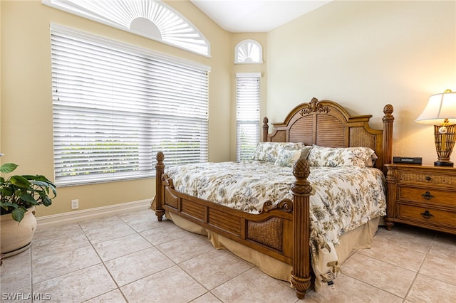 tiled bedroom featuring multiple windows