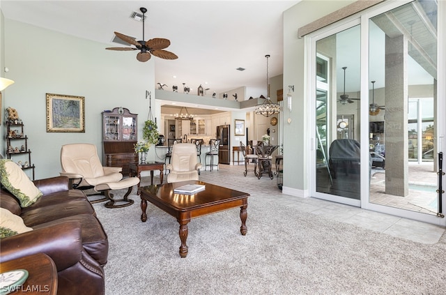 tiled living room with ceiling fan with notable chandelier