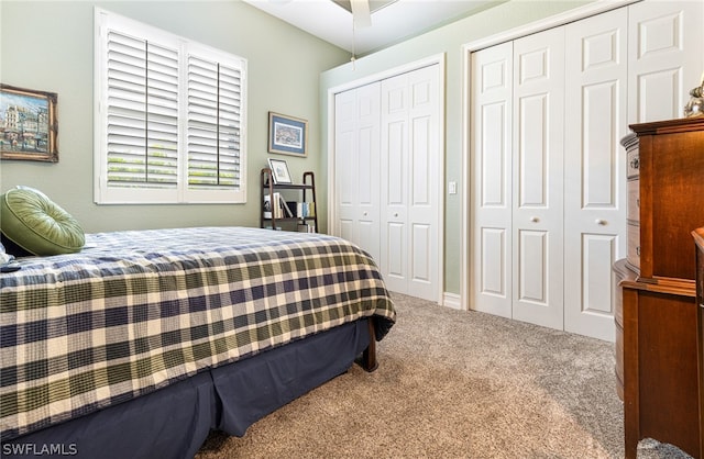 carpeted bedroom featuring two closets