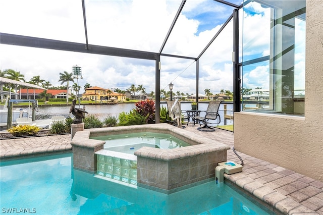 view of pool with a water view, an in ground hot tub, a patio area, and glass enclosure